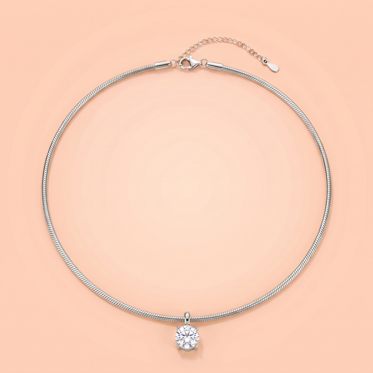 Unica Choker in silver laid flat on a peach background