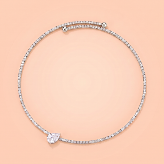 Giro Choker in silver laid flat on a peach background
