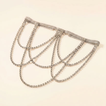 A silver-toned rhinestone chain choker with multiple draped loops, displayed on a plain light beige background.
