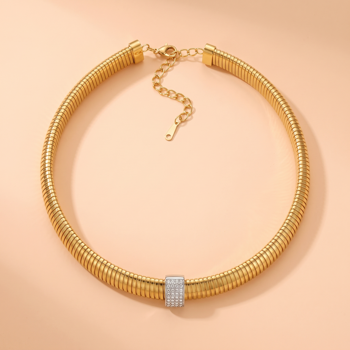 Stella Choker Gold flat lay on peach