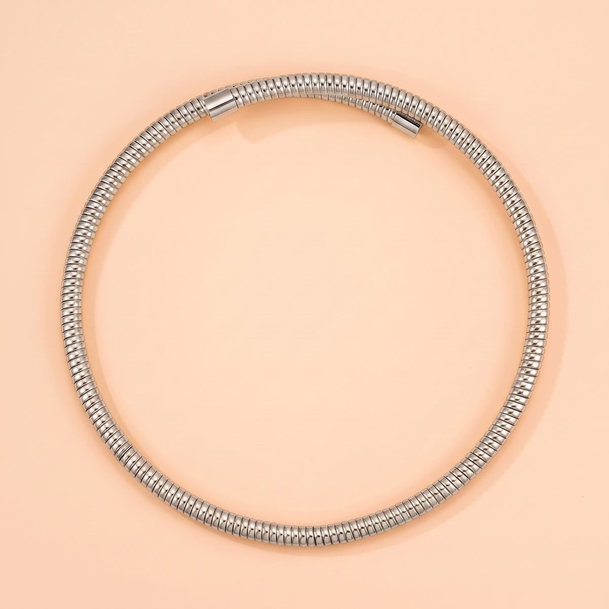 Spira Choker Silver flat lay on peach