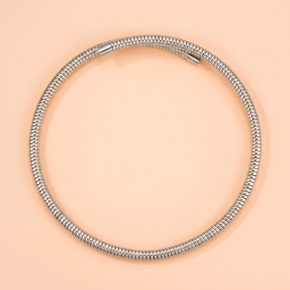 Spira Choker Silver flat lay on peach