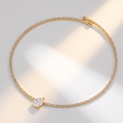 Giro Choker in gold on a white surface in soft sunlight