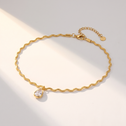 Onda Choker in gold on a white surface in soft sunlight