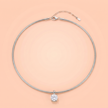 Unica Choker in silver laid flat on a peach background
