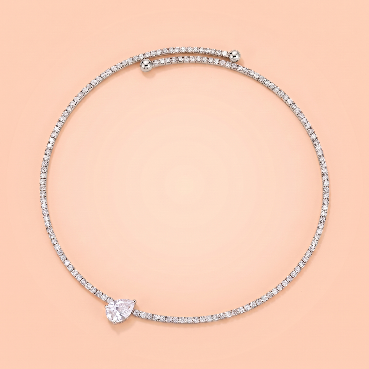 Giro Choker in silver laid flat on a peach background