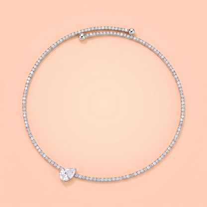 Giro Choker in silver laid flat on a peach background