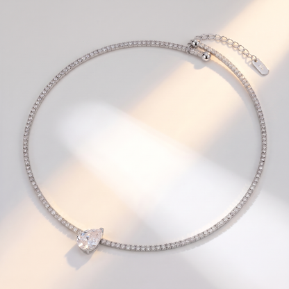 Giro Choker in silver on a white surface in soft sunlight