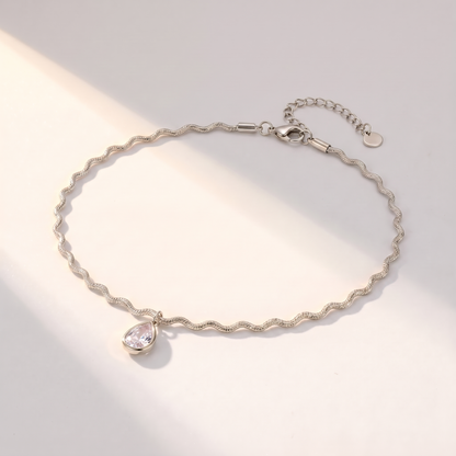 Onda Choker in silver on a white surface in soft sunlight