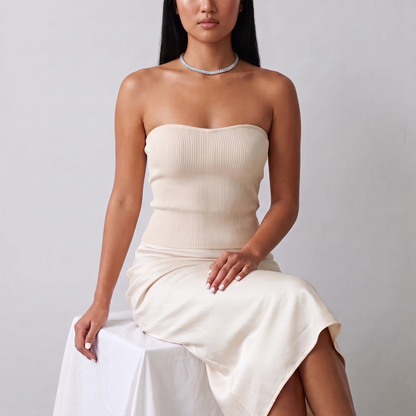 Model seated in a cream knit top wearing the Luce Choker in silver