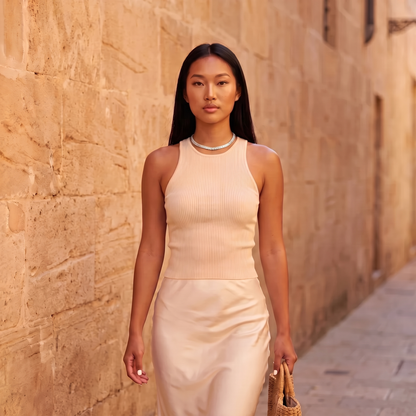 Model walking down a sunlit street wearing the Luce Choker in silver