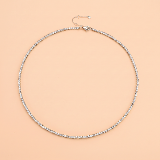Filo Choker in silver laid flat on a peach background