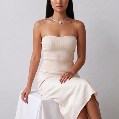 Model seated in a cream knit top wearing the Aura Choker in silver