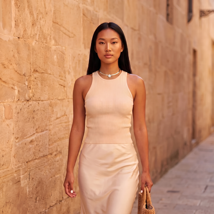 Model walking down a sunlit street wearing the Aura Choker in silver