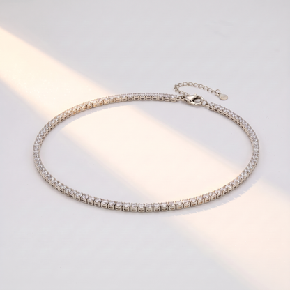 Filo Choker in silver on a white surface in soft sunlight